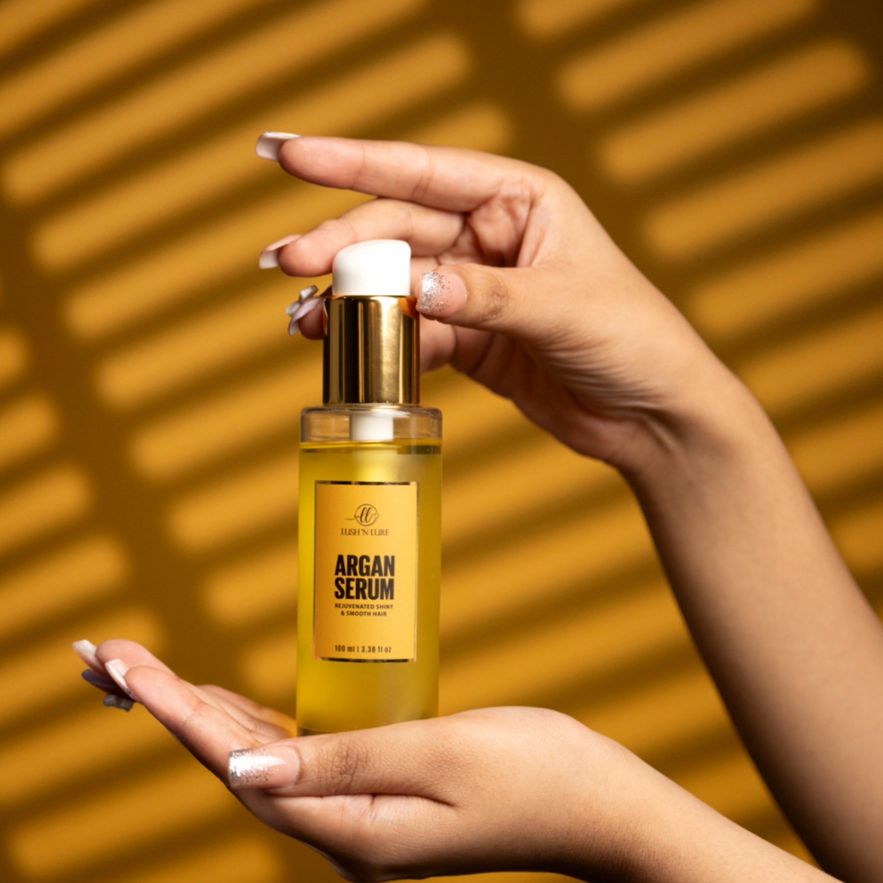 "Model applying LUSHNLURE Argan Serum to her hair, showcasing its smooth texture and shine, with a natural, glowing look. The serum is designed to nourish and hydrate hair, leaving it silky and frizz-free."