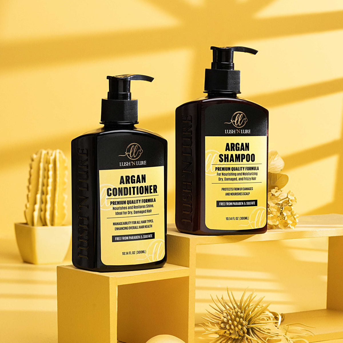 "LUSH 'N LURE Argan Shampoo and Conditioner duo displayed together with argan nuts and leaves, highlighting their nourishing formulas designed to hydrate and soften hair."