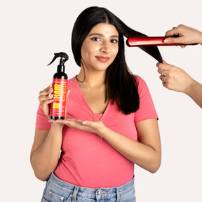 "Model spraying LUSHNLURE Heat Protection Spray onto her hair before styling, demonstrating its lightweight formula that shields hair from heat damage. The spray helps maintain smoothness and shine while protecting against styling tools."