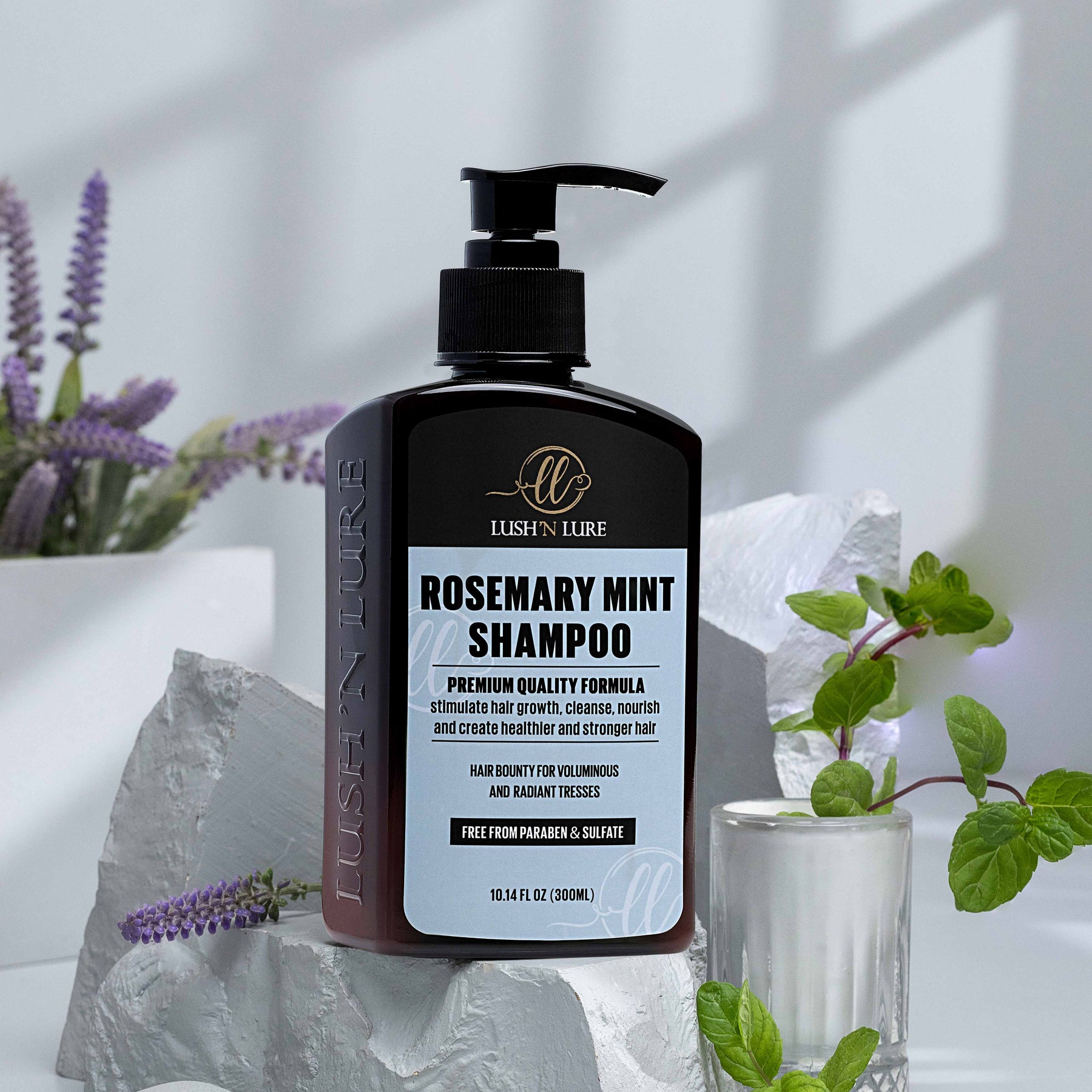 "LUSH 'N LURE Rosemary Shampoo bottle presented with fresh rosemary sprigs, highlighting its invigorating formula designed to promote hair growth and scalp health."